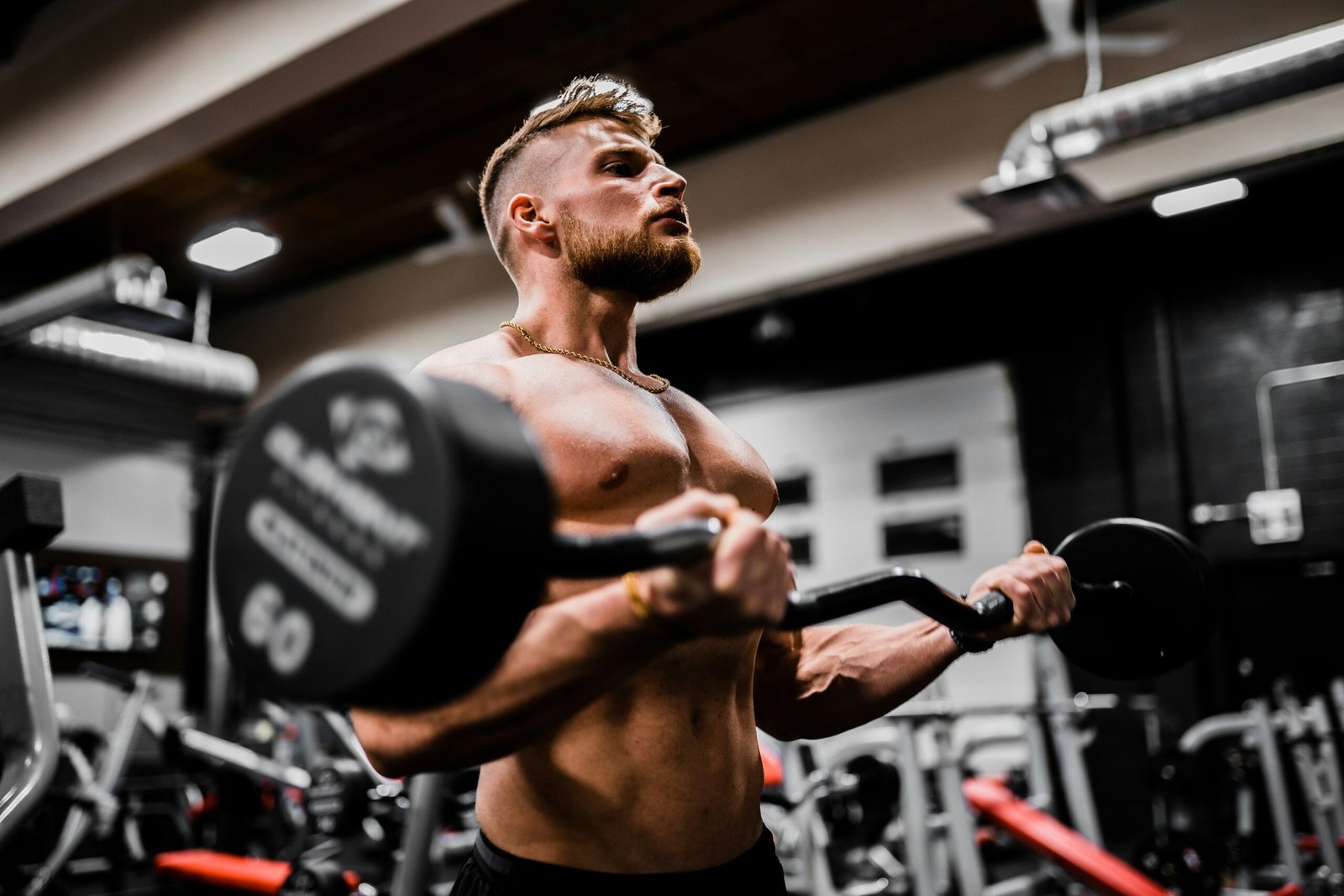 Guy working out with an EZ bar