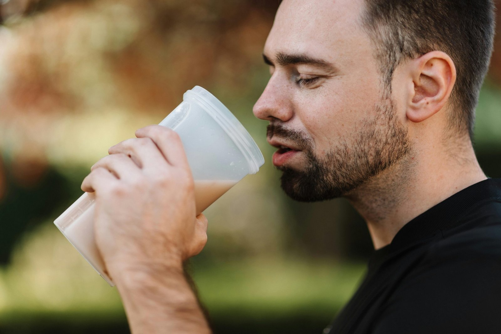 Man drinking a shake outside