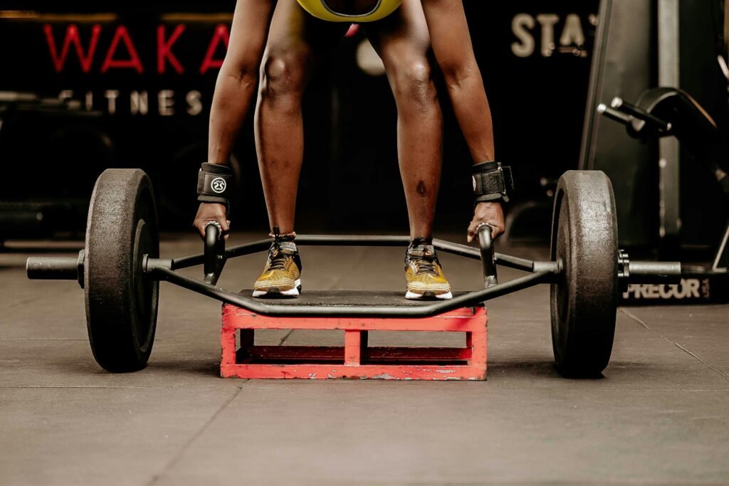 Person doing a deadlift with a trap bar indoors