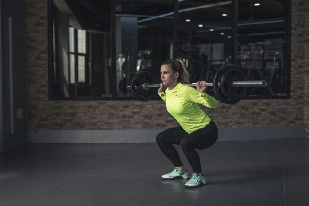 Woman squatting with a barbell